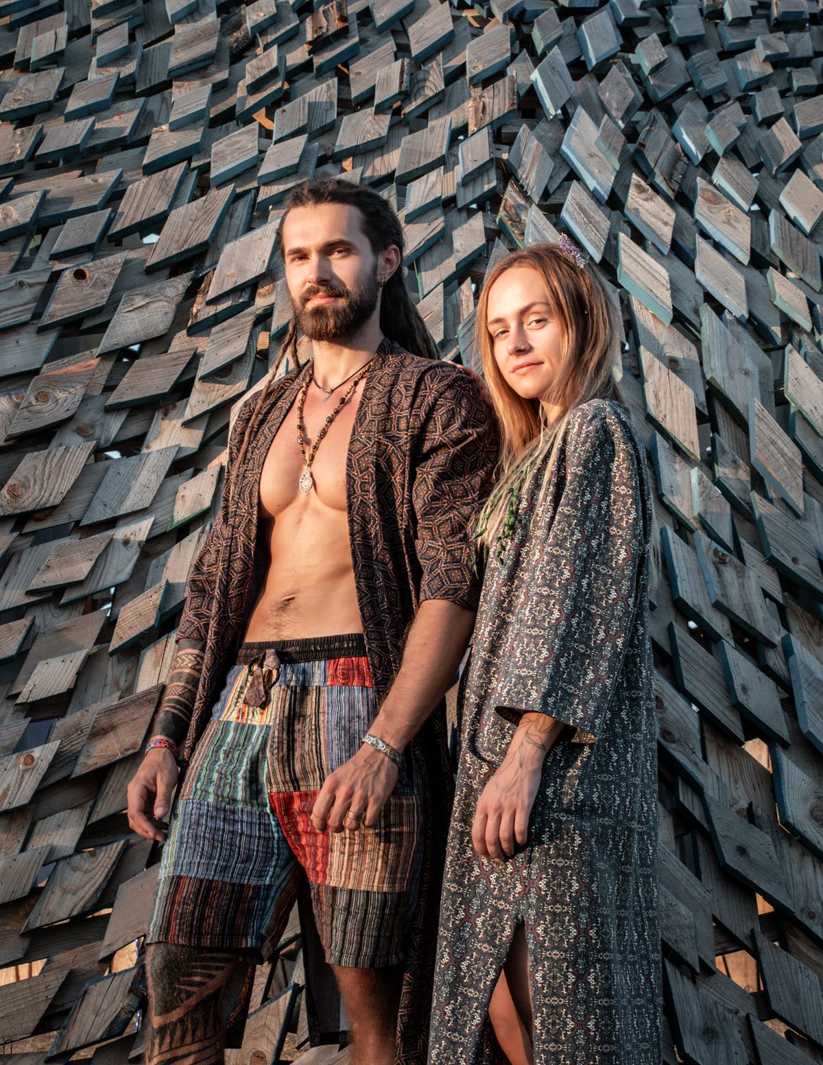 Couple dancing at Ozora festival wearing SOL psychedelic print kimonos