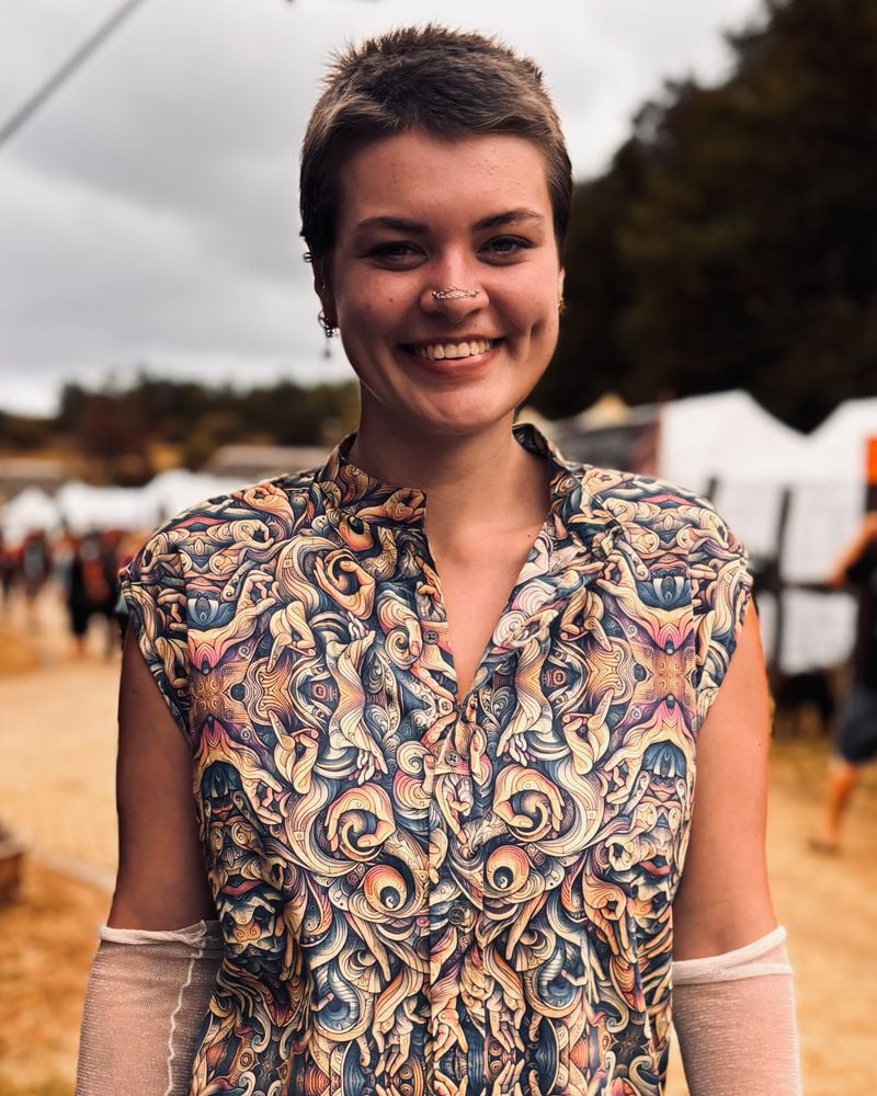 Man at Ozora festival in a SOL printed button shirt