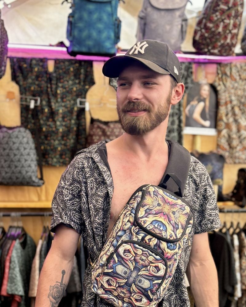 Festival goer at Ozora wearing a SOL printed sling bag